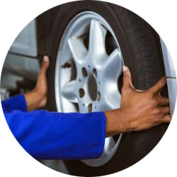 Auto Mechanic putting on tires at Oliver Towing and Recovery
