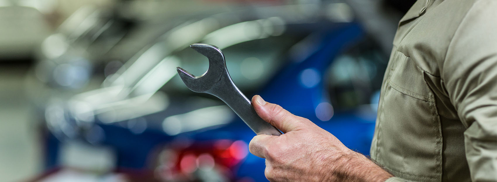Closeup of an auto mechanic holding a wrench at Supreme Auto Repair